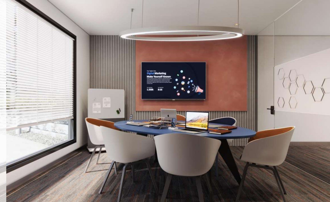 Meeting pod with soft pink accent wall and round table