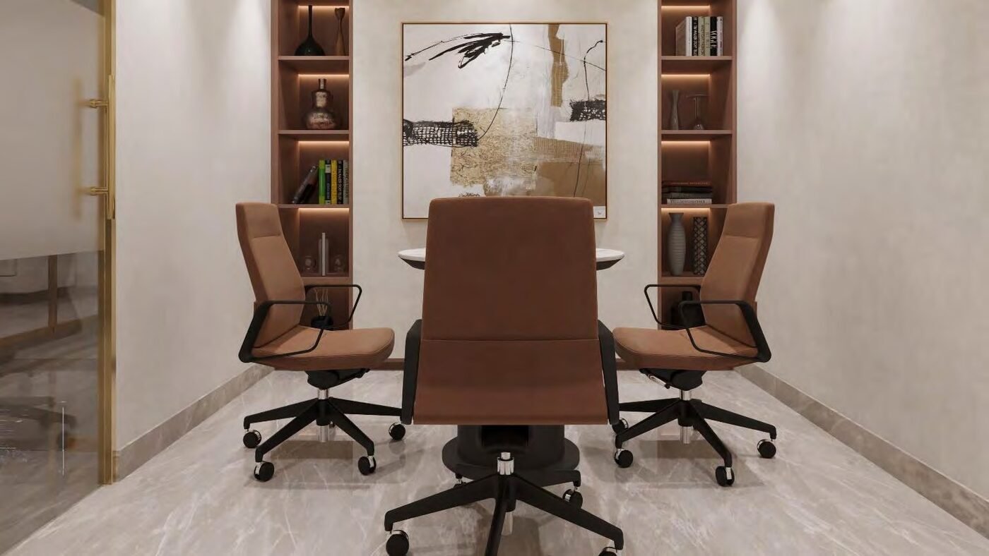 Small meeting room with cognac leather chairs and artwork