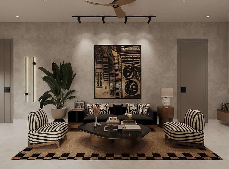 Living room with statement wall art, black sofa and striped armchairs